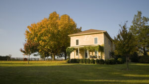 A picture of a home in a rural setting during sunset.