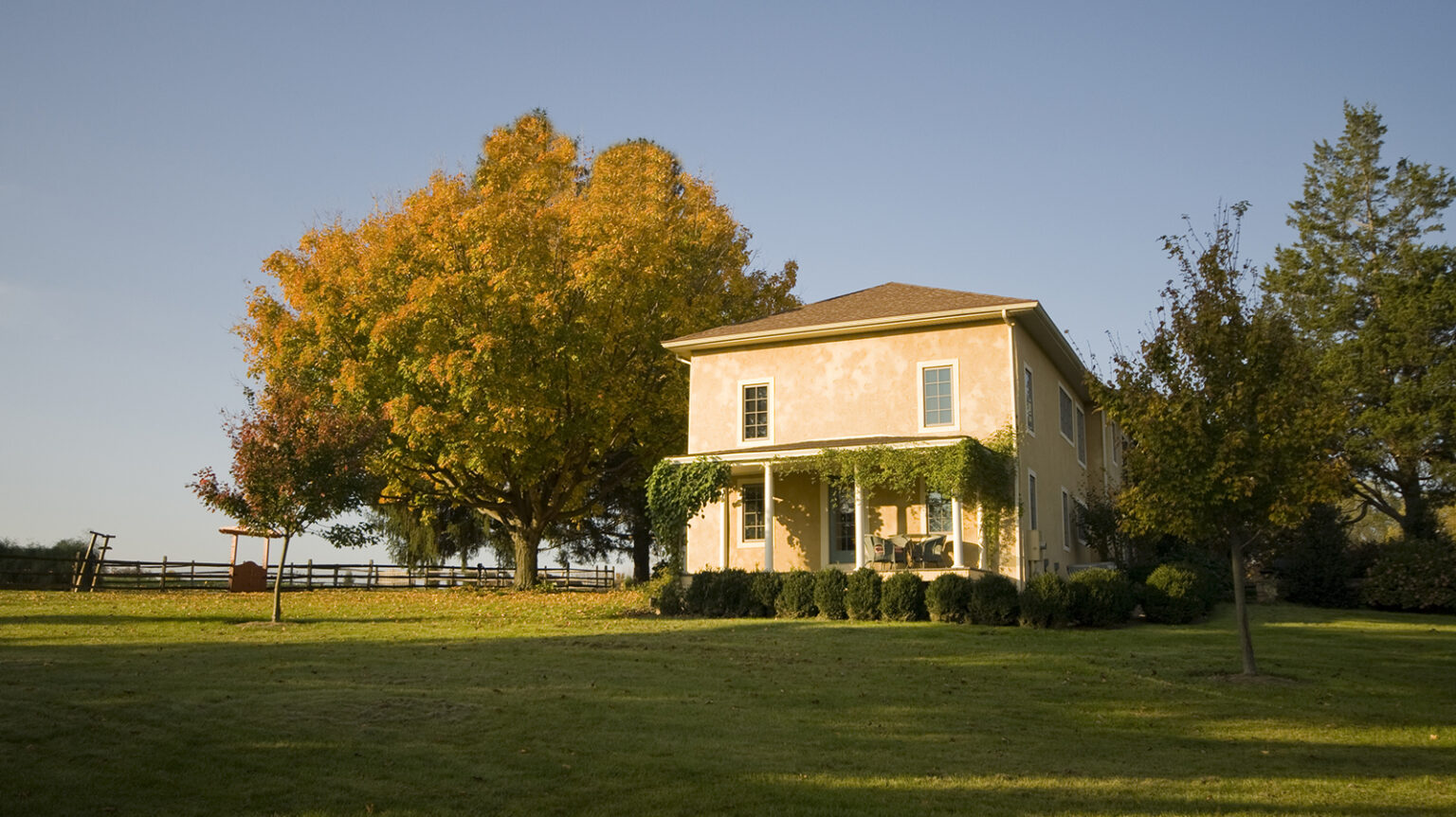 A picture of a home in a rural setting during sunset.