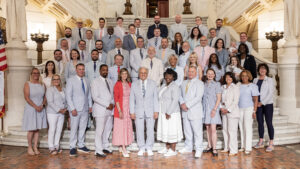 Sen. Bartolotta poses with a large group of people on the Capitol rotunda stairs.