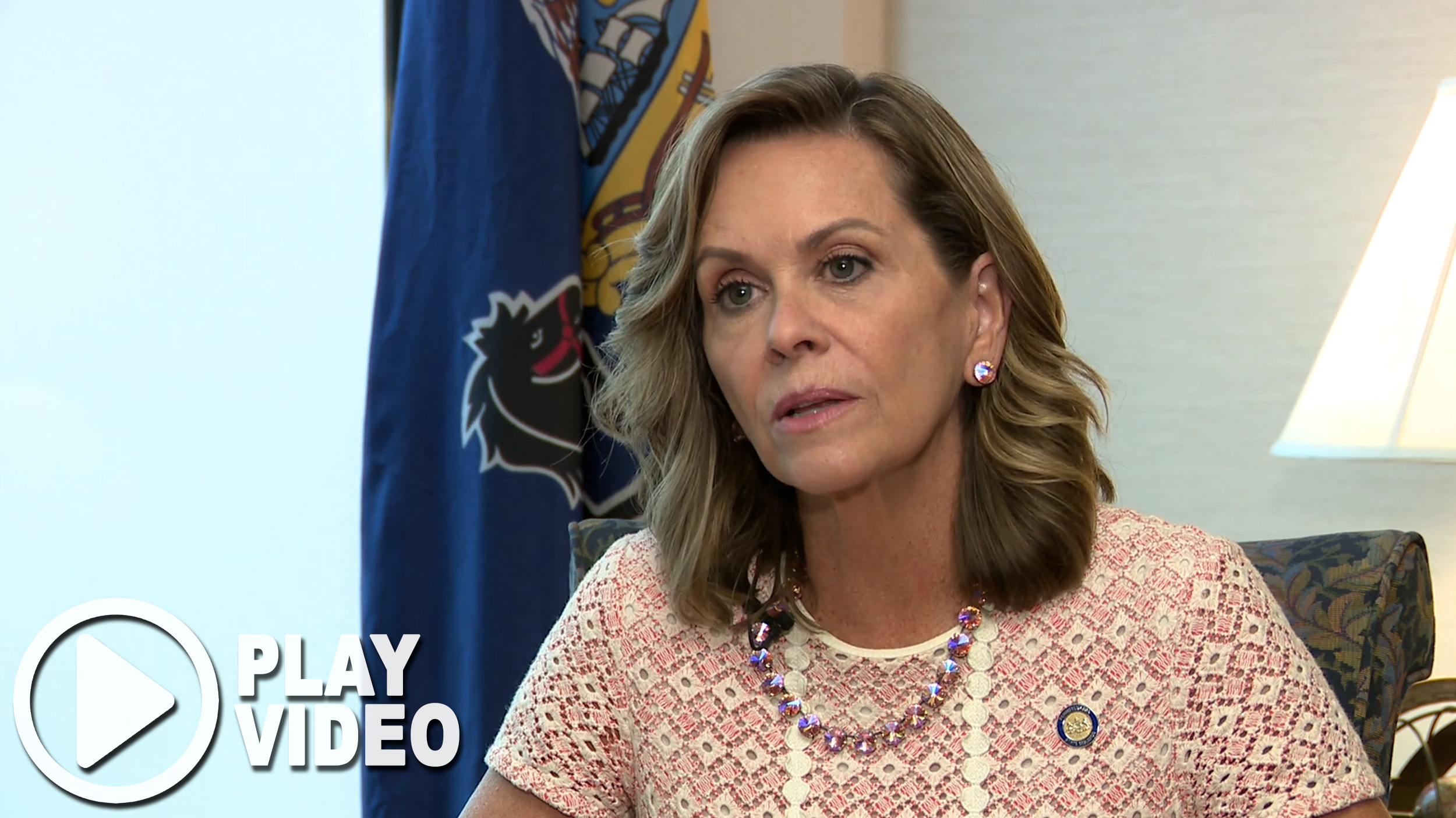 Sen. Bartolotta is sitting and talking in an office. At the bottom lefthand corner is a play button graphic overlay.
