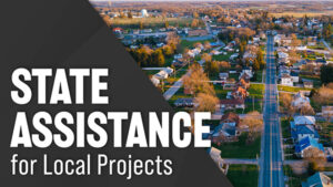 Text that says, “State Assistance for Local Projects” is overlayed onto a photo of a neighborhood.