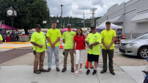 Sen. Bartolotta poses with a group of men in bright, neon green shirts at the festival in Charleroi.
