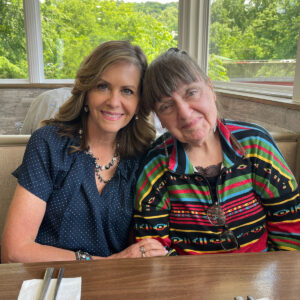 Sen. Bartolotta poses with Debby Baird-McKinney sitting in a restaurant booth.