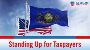US flag flying behind the PA flag with the words Standing Up for Taxpayers beneath them.