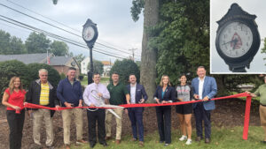Sen. Bartolotta poses with a group of people moments before cutting a ceremonial ribbon.