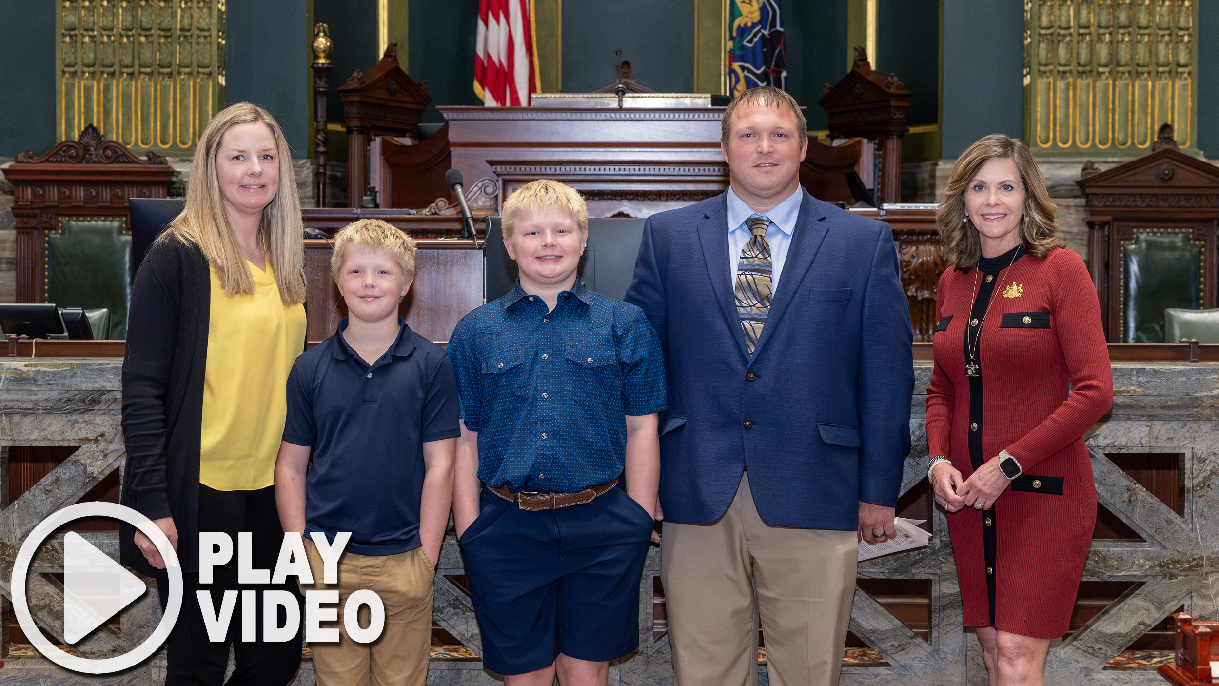 Senator Bartolotta poses with Pastor Lanfer Simpson and his family on the senate floor.